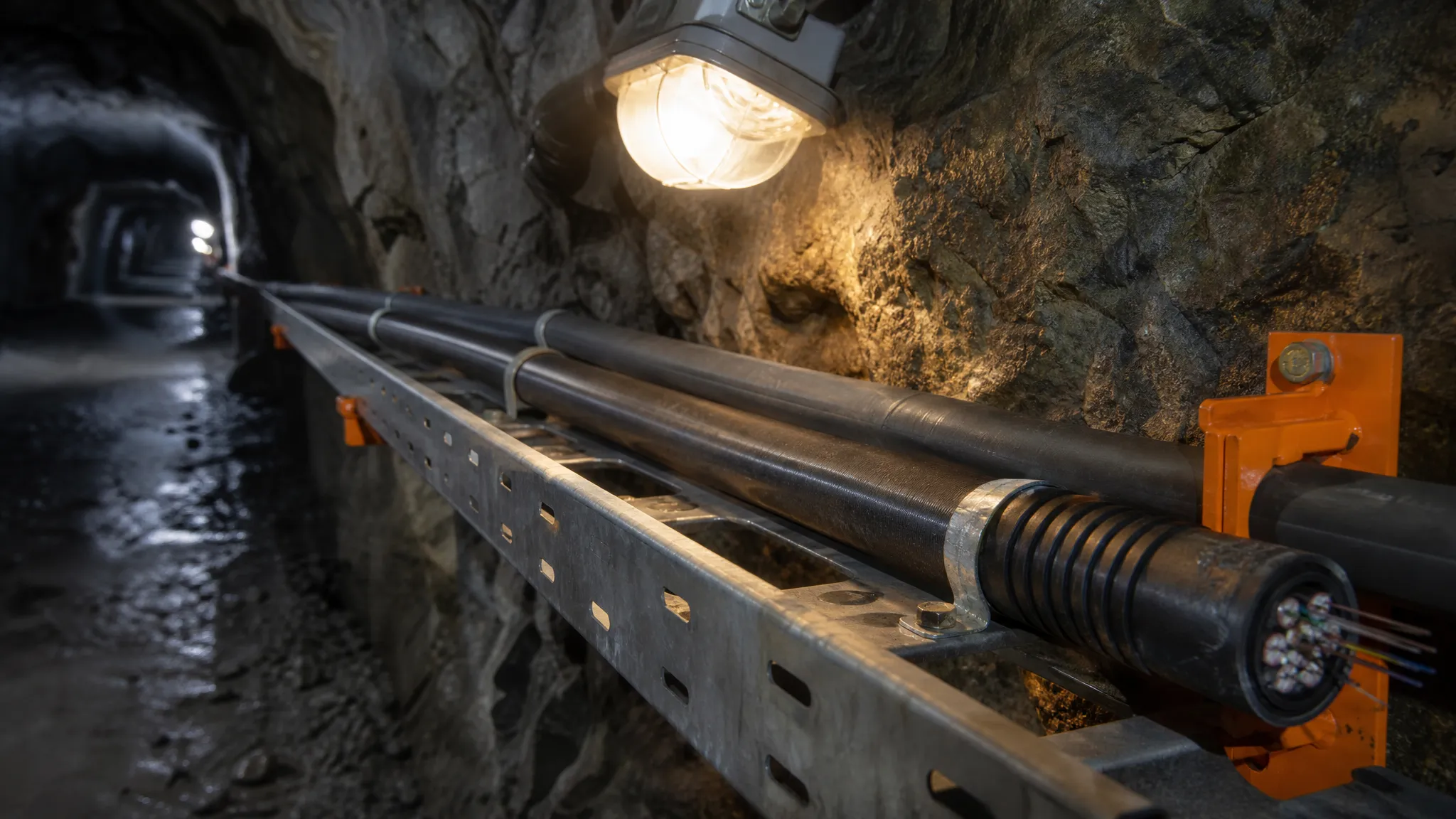 Armored loose-tube fiber optic cable installed in a cable tray inside an underground mine